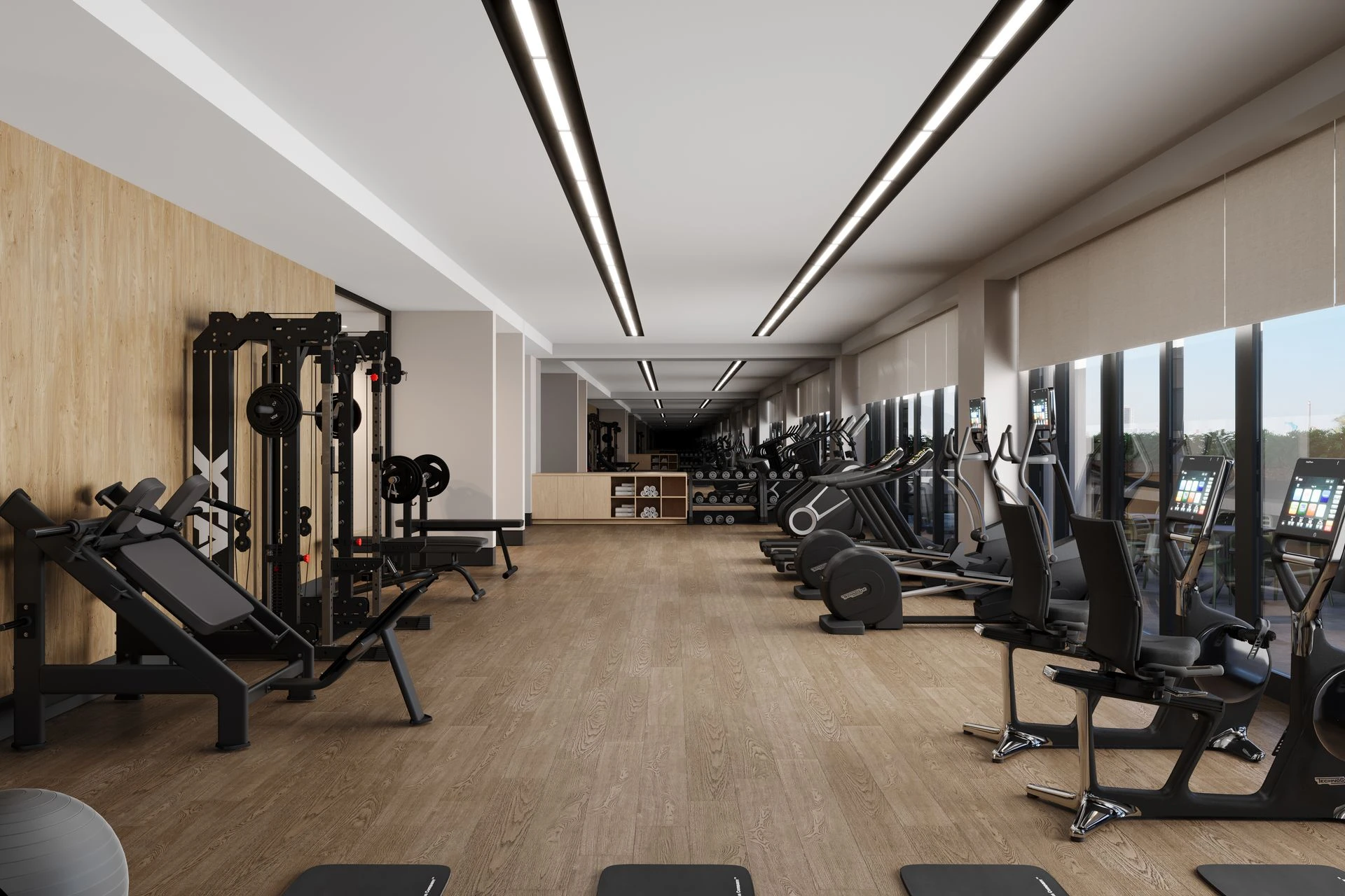 Gimnasio interior con equipos de cardio y pesas